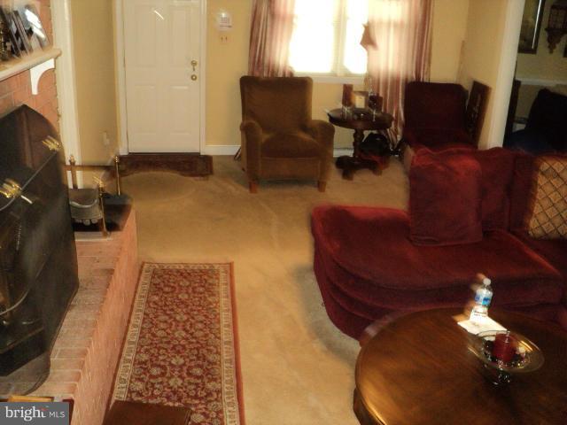 6702 Springbrook Lane Clinton, MD 20735 - Photo 18 of 30 a living room with furniture and a fireplace