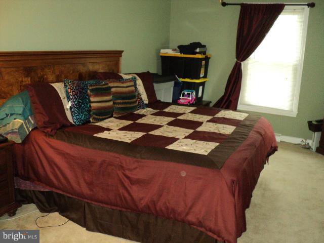 6702 Springbrook Lane Clinton, MD 20735 - Photo 3 of 30 a bedroom with a bed and a window