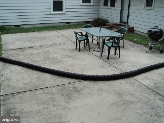 6702 Springbrook Lane Clinton, MD 20735 - Photo 29 of 30 a view of a backyard with a table and chairs