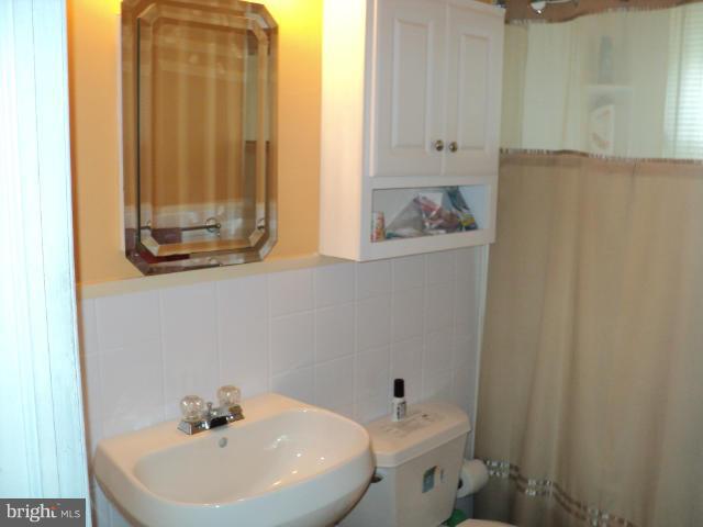 6702 Springbrook Lane Clinton, MD 20735 - Photo 6 of 30 a bathroom with a sink and a mirror