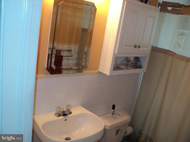 6702 Springbrook Lane Clinton, MD 20735 - Photo 7 of 30 a bathroom with a sink and mirror with toilet