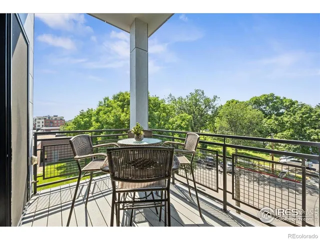 a view of balcony with chairs and wooden fence