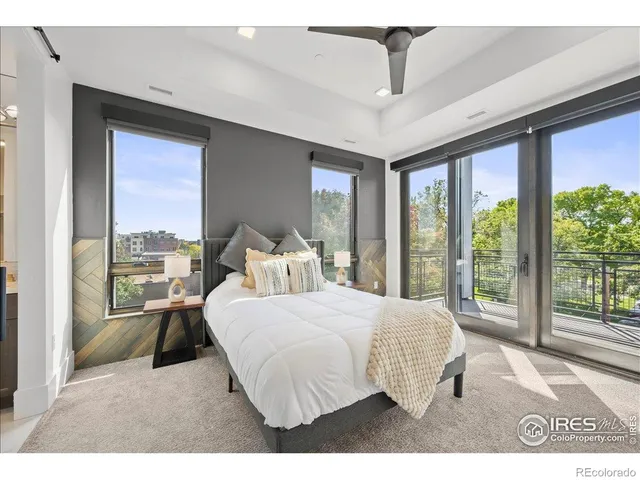 a bedroom with a large bed and a large window