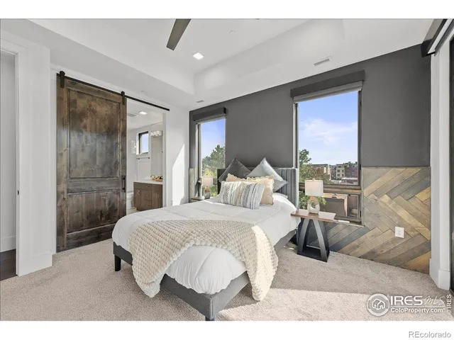 a bedroom with a bed and a mirror