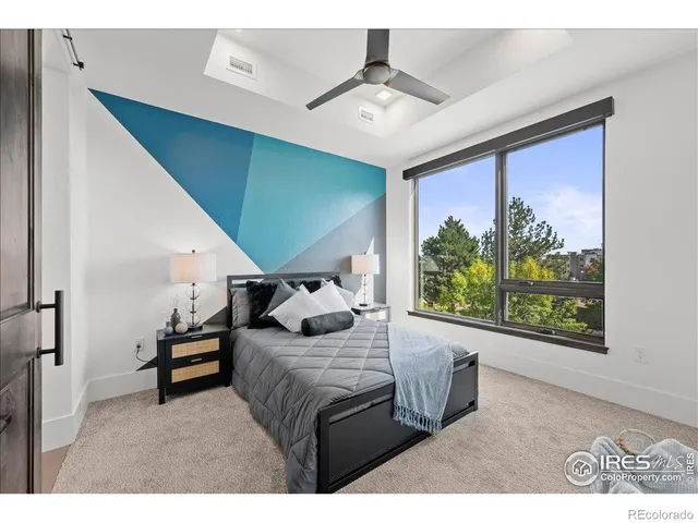 a bedroom with furniture and a large window