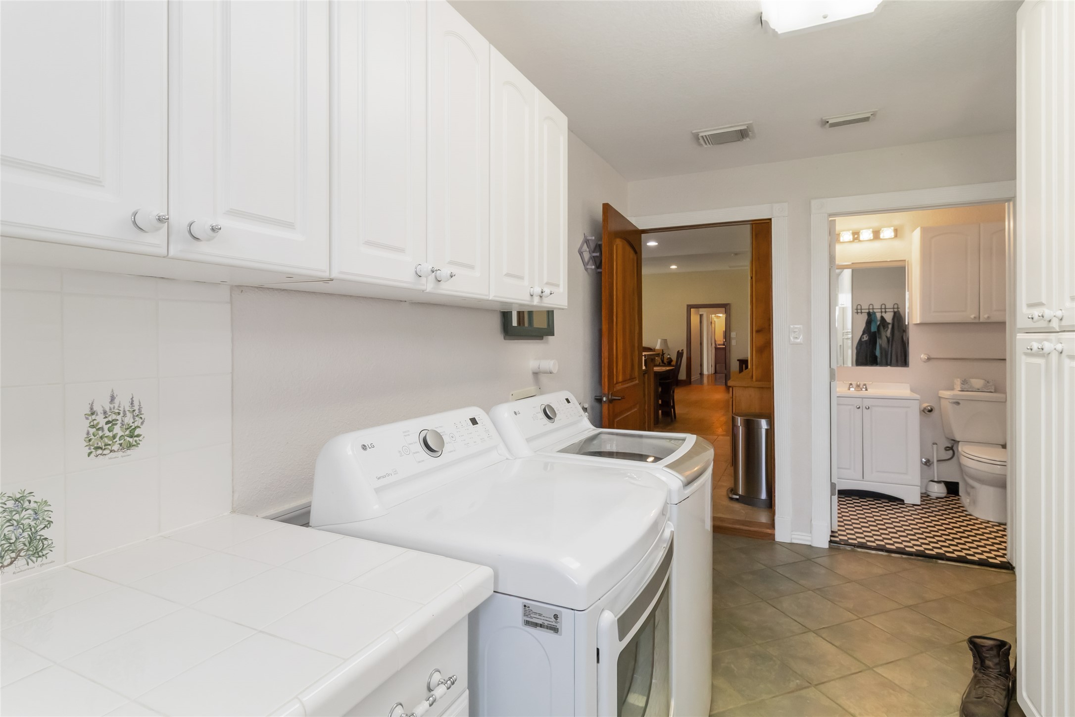 1208 Jeddo Road Rosanky, TX 78953 - Photo 26 of 40 Functional laundry space featuring convenient upper cabinetry and durable tile flooring.