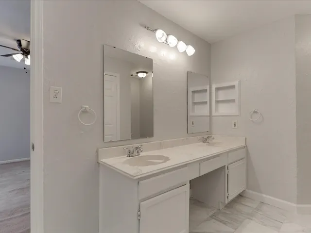 a bathroom with a sink vanity and a mirror