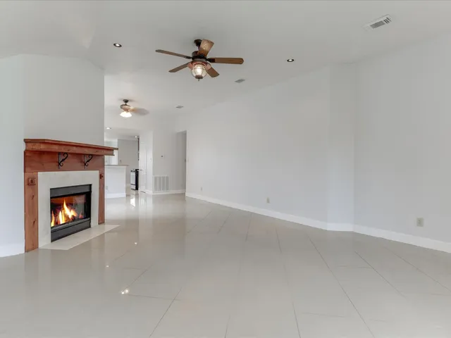 a view of an empty room with a fireplace