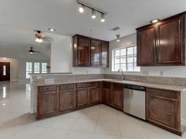 a large kitchen with a sink and dishwasher cabinets