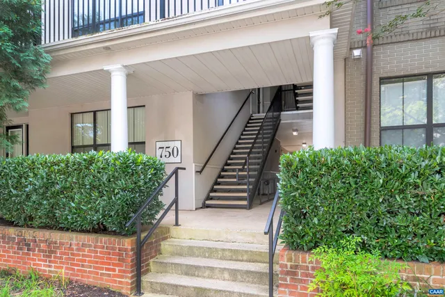 a front view of a residential apartment building with a yard