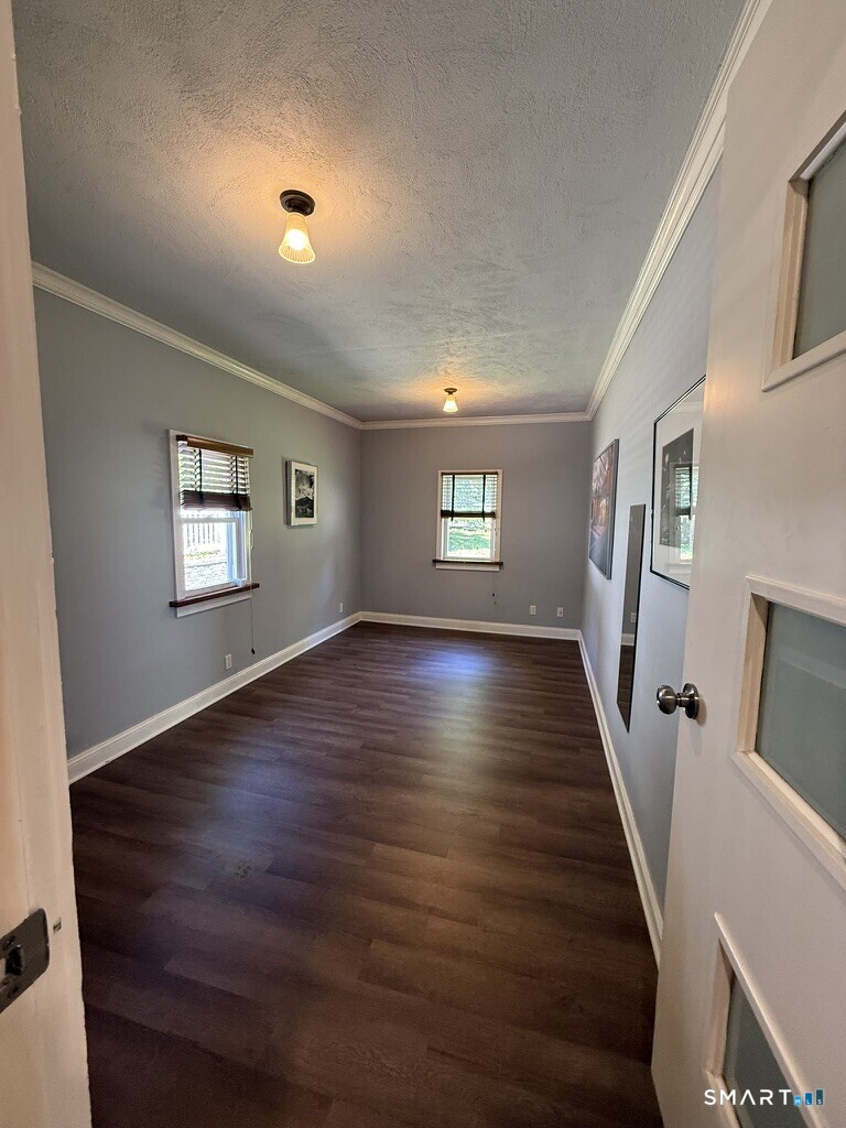 2182 North Benson Road Fairfield, CT 06824 - Photo 10 of 21 a view of an empty room with wooden floor and a window