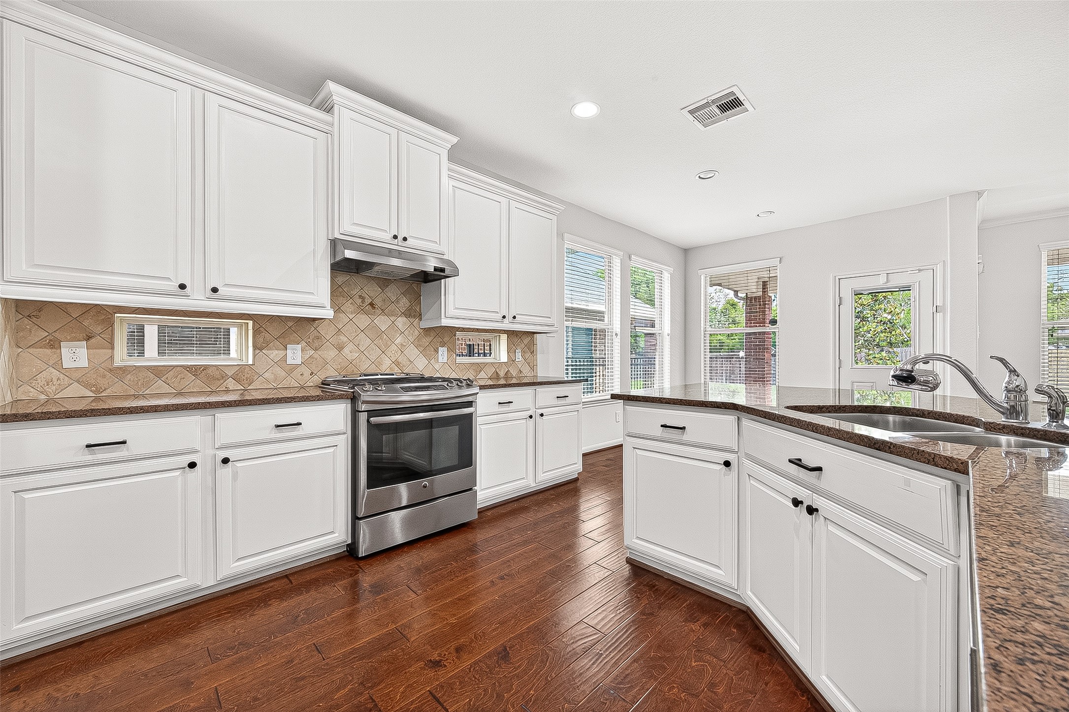 138 South Sawbridge Circle Spring, TX 77389 - Photo 13 of 37 a kitchen with granite countertop white cabinets and white appliances