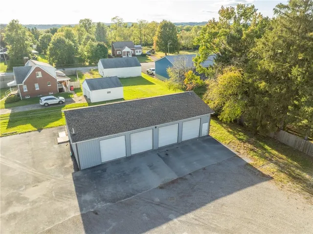 a view of a swimming pool with a patio and a yard