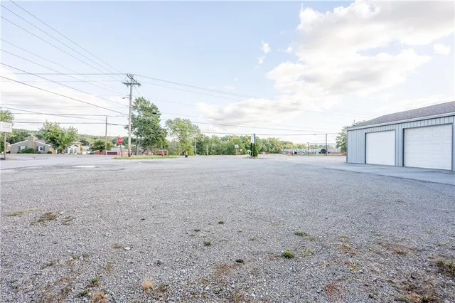 a view of a dirt road and a building