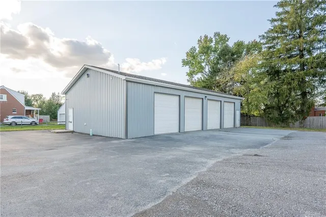 a view of a house with a backyard and garage