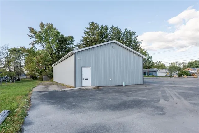 a view of a house with a yard and garage