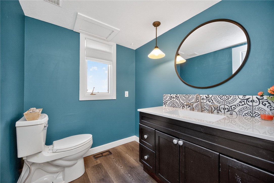 4747 Fawnwood Road Dayton, OH 45429 - Photo 21 of 58 This bathroom features hardwood flooring, a single vanity, and a window for natural light.