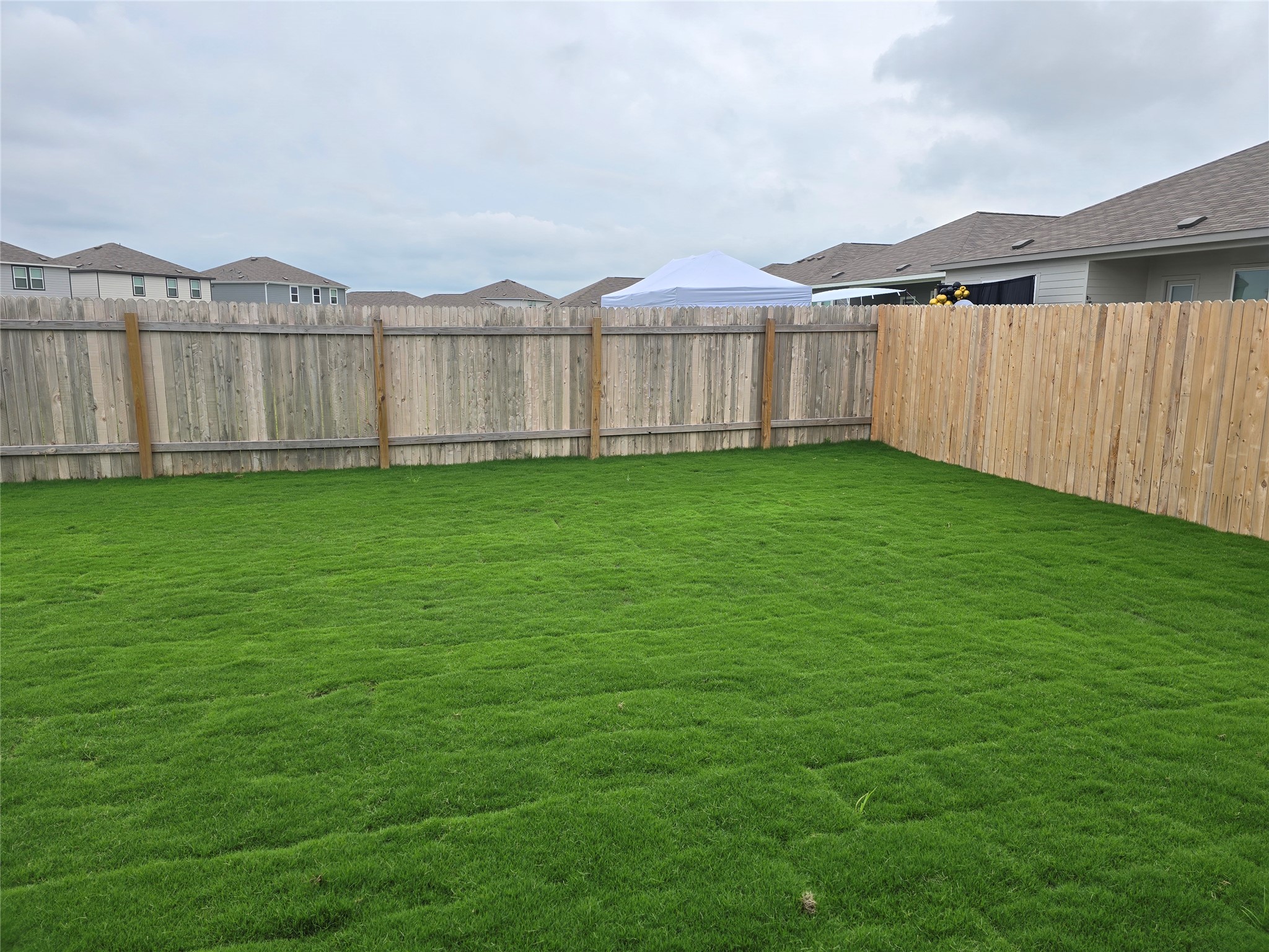 509 McFadin Way Taylor, TX 76574 - Photo 21 of 23 a view of a backyard with a garden