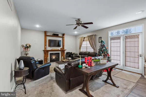 a living room with furniture fireplace and window