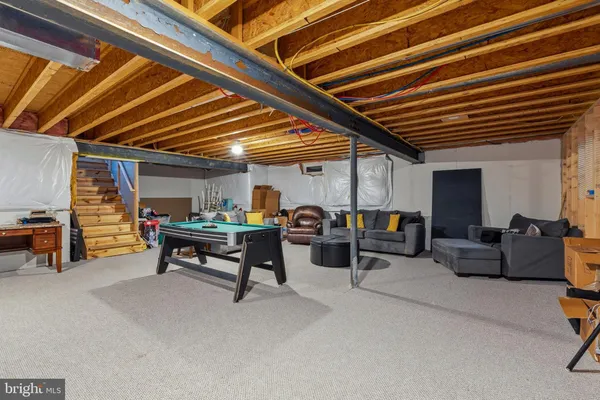 a living room with furniture and a kitchen