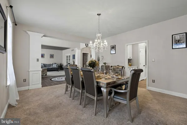a view of a dining room with furniture and chandelier