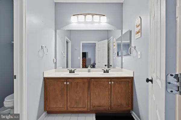 a bathroom with a double vanity sink and a mirror