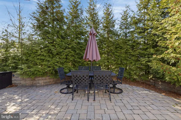 a view of patio with a table and chairs and potted plants