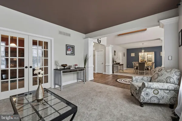 a living room with furniture and a dining table with kitchen view