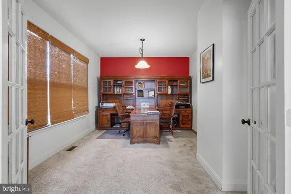 a dining room with furniture and a window