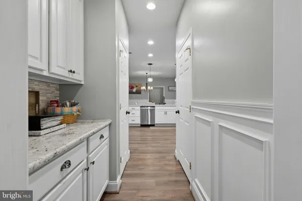 a kitchen with granite countertop a sink and cabinets
