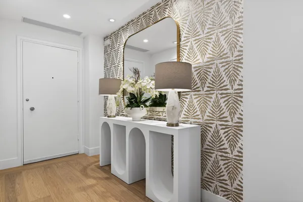a room with stainless steel appliances a stove a chimney and a window