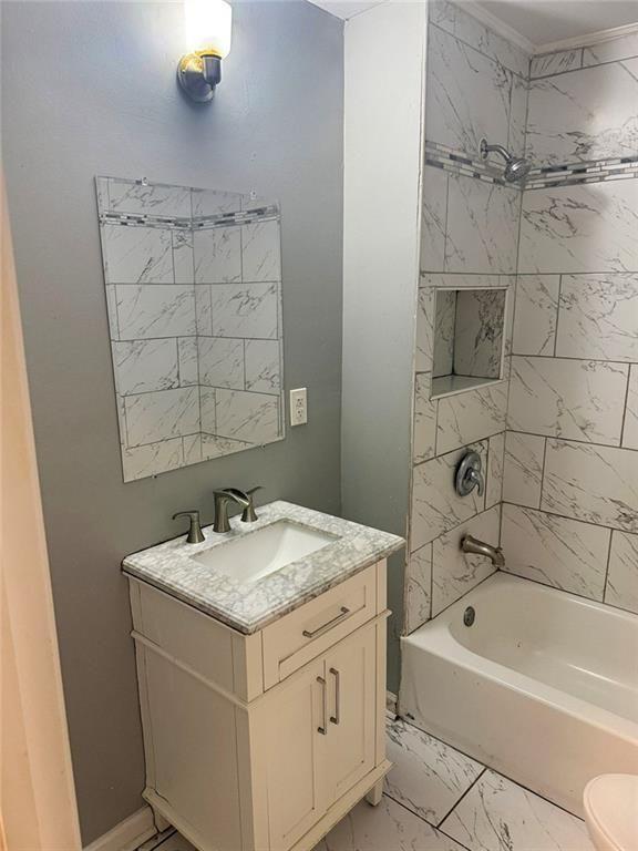 4330 Stonewall Tell Road Atlanta, GA 30349 - Photo 17 of 39 a bathroom with a granite countertop sink a toilet and bathtub