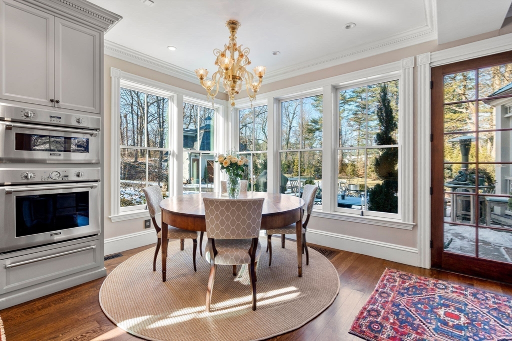 215 Boston Post Road Weston, MA 02493 - Photo 17 of 37 a dining room with furniture a chandelier and wooden floor