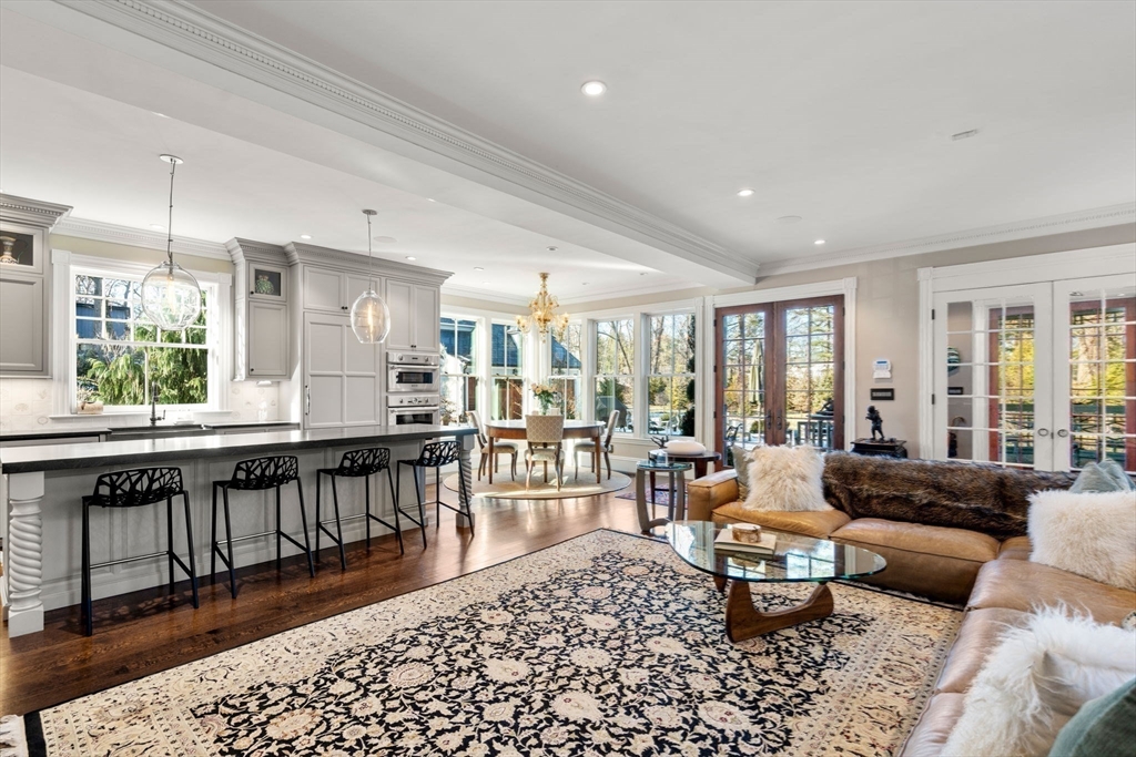 215 Boston Post Road Weston, MA 02493 - Photo 18 of 37 a living room with furniture a rug and a large window