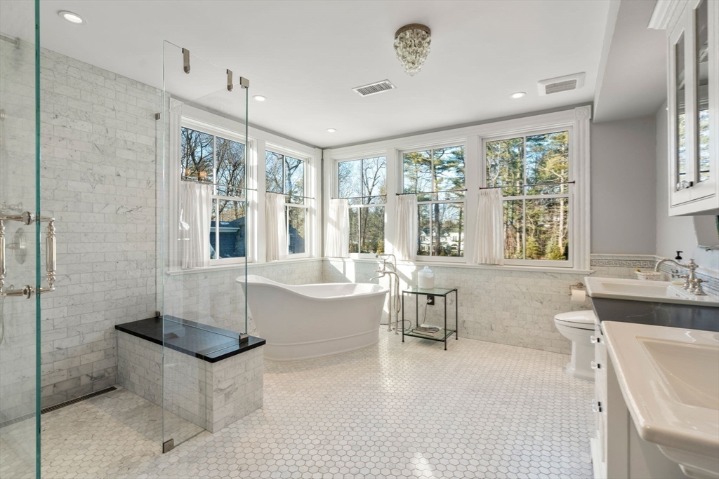 215 Boston Post Road Weston, MA 02493 - Photo 23 of 37 a spacious bathroom with a tub a double vanity sink a mirror and a shower