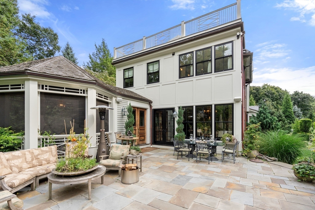 215 Boston Post Road Weston, MA 02493 - Photo 5 of 37 a view of a patio with dining table and chairs and potted plants