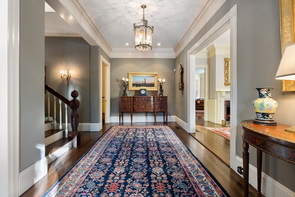 215 Boston Post Road Weston, MA 02493 - Photo 8 of 37 a hallway with dining area and chandelier