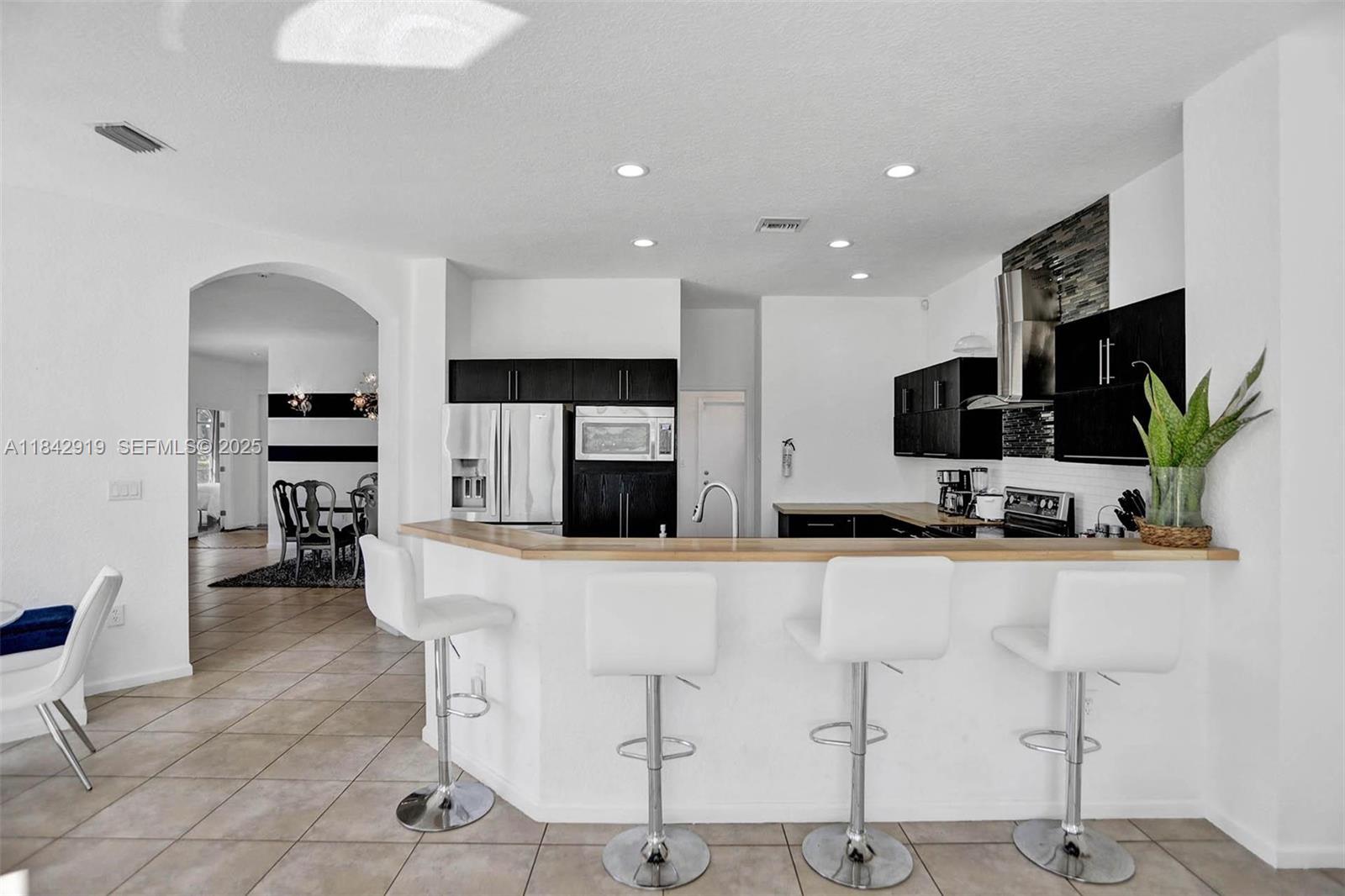 721 Ranch Road Weston, FL 33326 - Photo 37 of 38 a kitchen with stainless steel appliances kitchen island granite countertop a refrigerator and a stove top oven