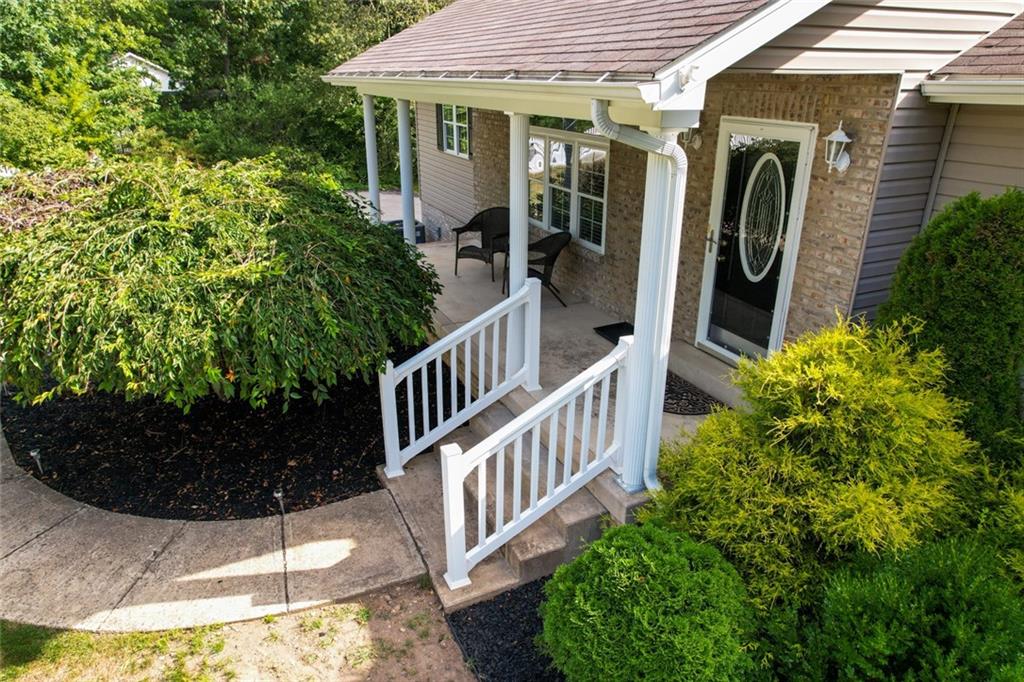 131 Hunter Ridge Road Butler, PA 16001 - Photo 3 of 45 a view of a wooden house with a flower garden