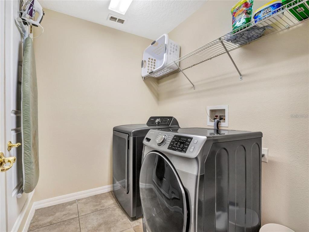 10023 Ians Ridge Road Orlando, FL 32832 - Photo 39 of 60 a utility room with dryer and washer