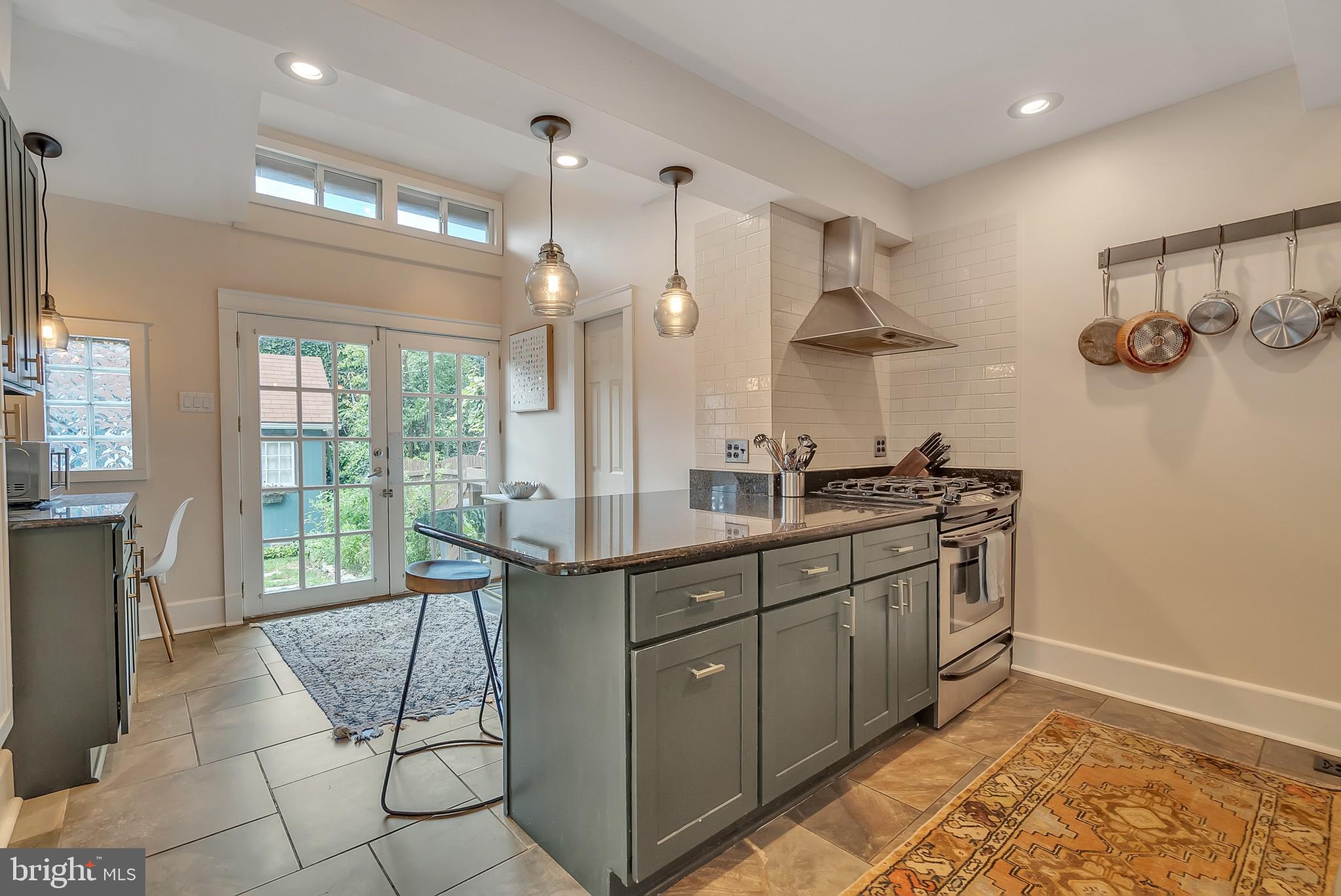 229 Benezet Street Philadelphia, PA 19118 - Photo 13 of 36 a spacious bathroom with a double vanity sink a mirror and a shower