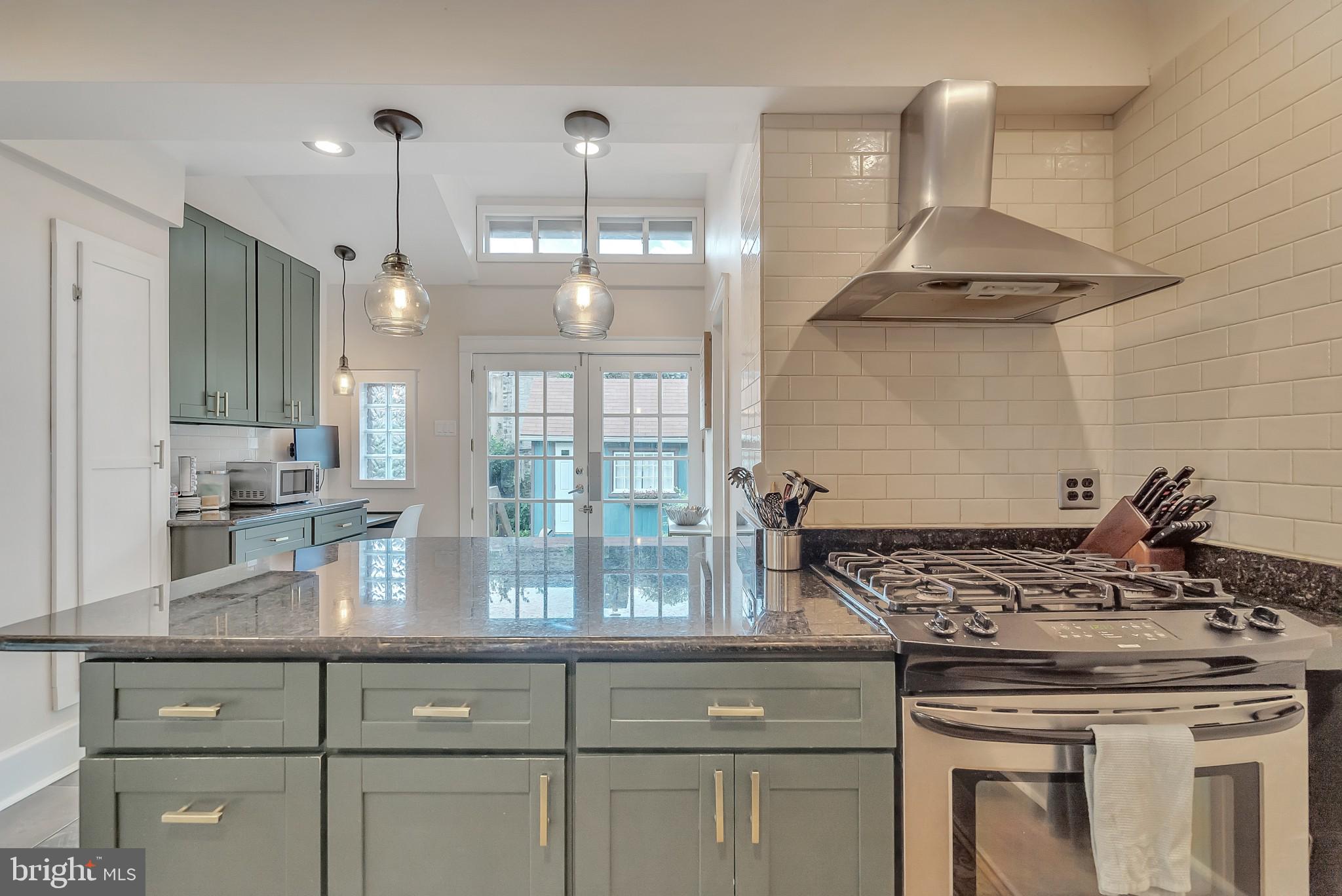 229 Benezet Street Philadelphia, PA 19118 - Photo 17 of 36 a kitchen with a stove and a wooden floor