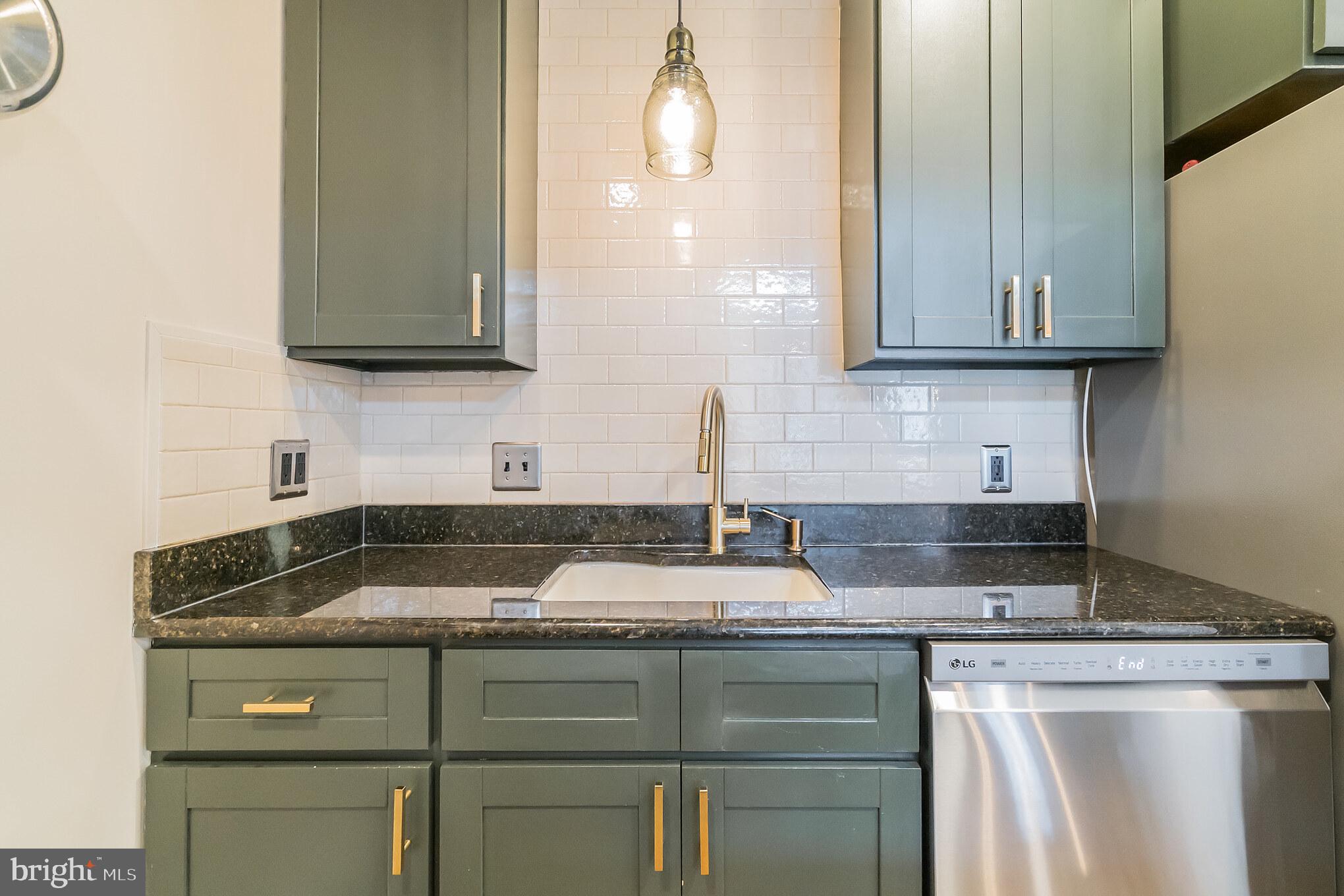 229 Benezet Street Philadelphia, PA 19118 - Photo 18 of 36 a kitchen with granite countertop a sink and cabinets