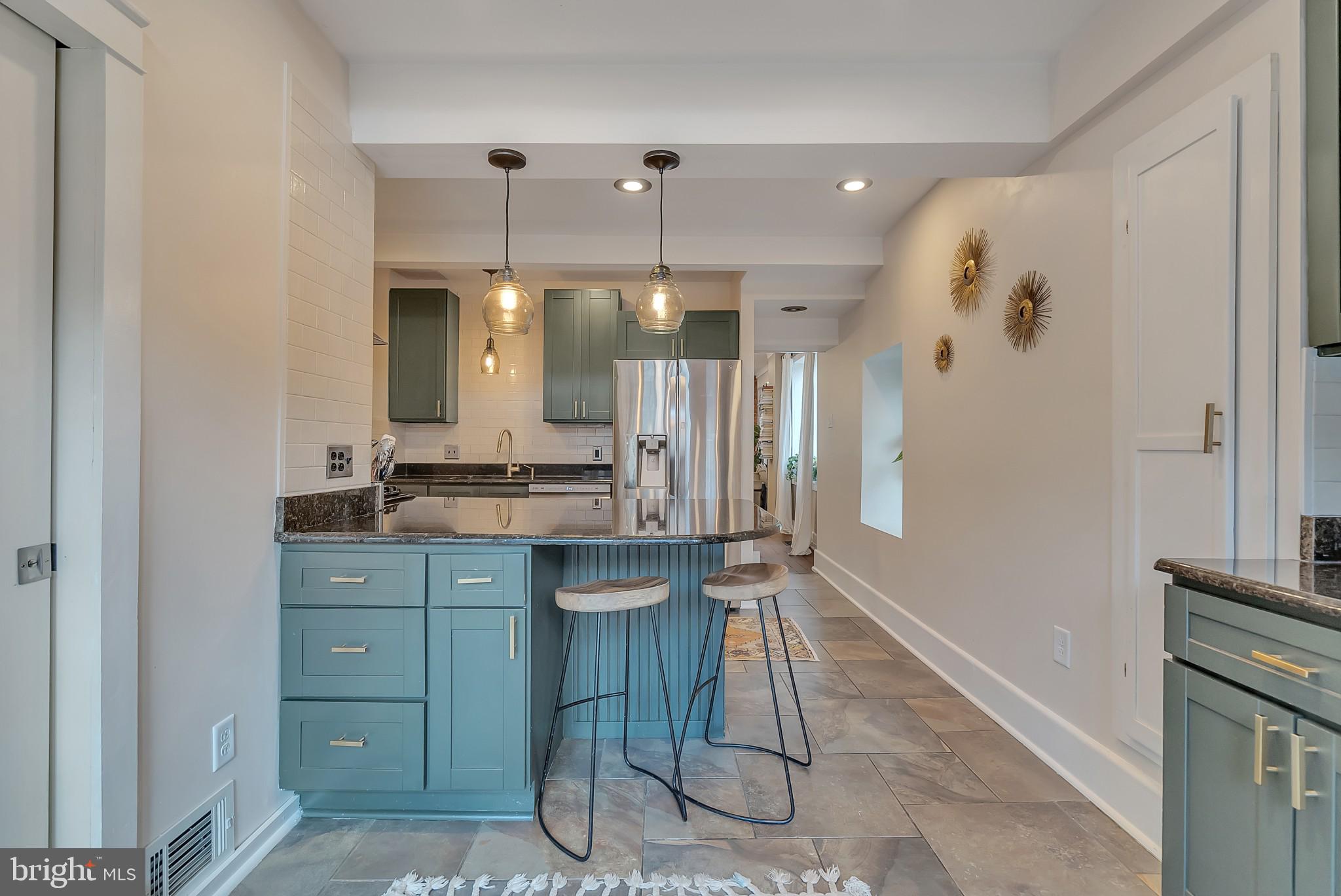 229 Benezet Street Philadelphia, PA 19118 - Photo 19 of 36 a bathroom with a sink vanity and a mirror