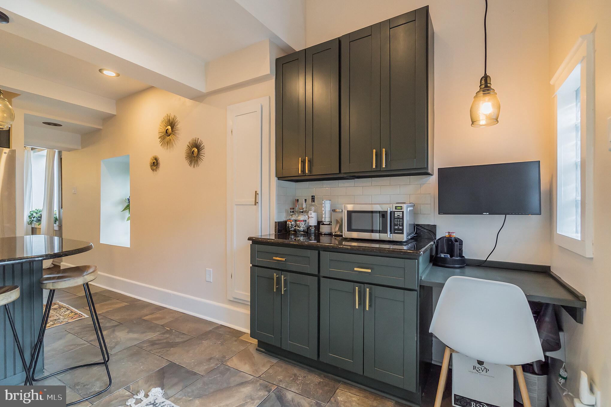 229 Benezet Street Philadelphia, PA 19118 - Photo 20 of 36 a kitchen with granite countertop a sink cabinets and wooden floor