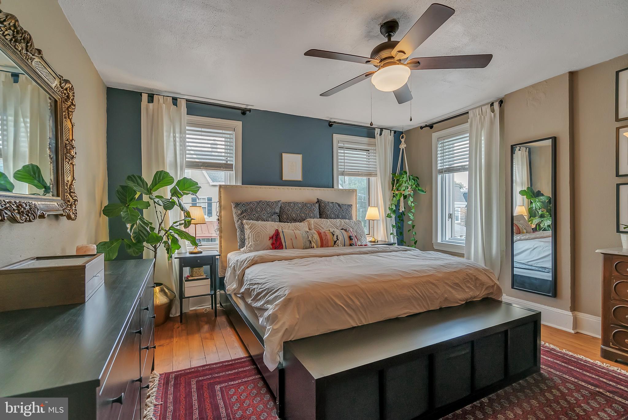 229 Benezet Street Philadelphia, PA 19118 - Photo 24 of 36 a bedroom with a large bed chandelier and a window