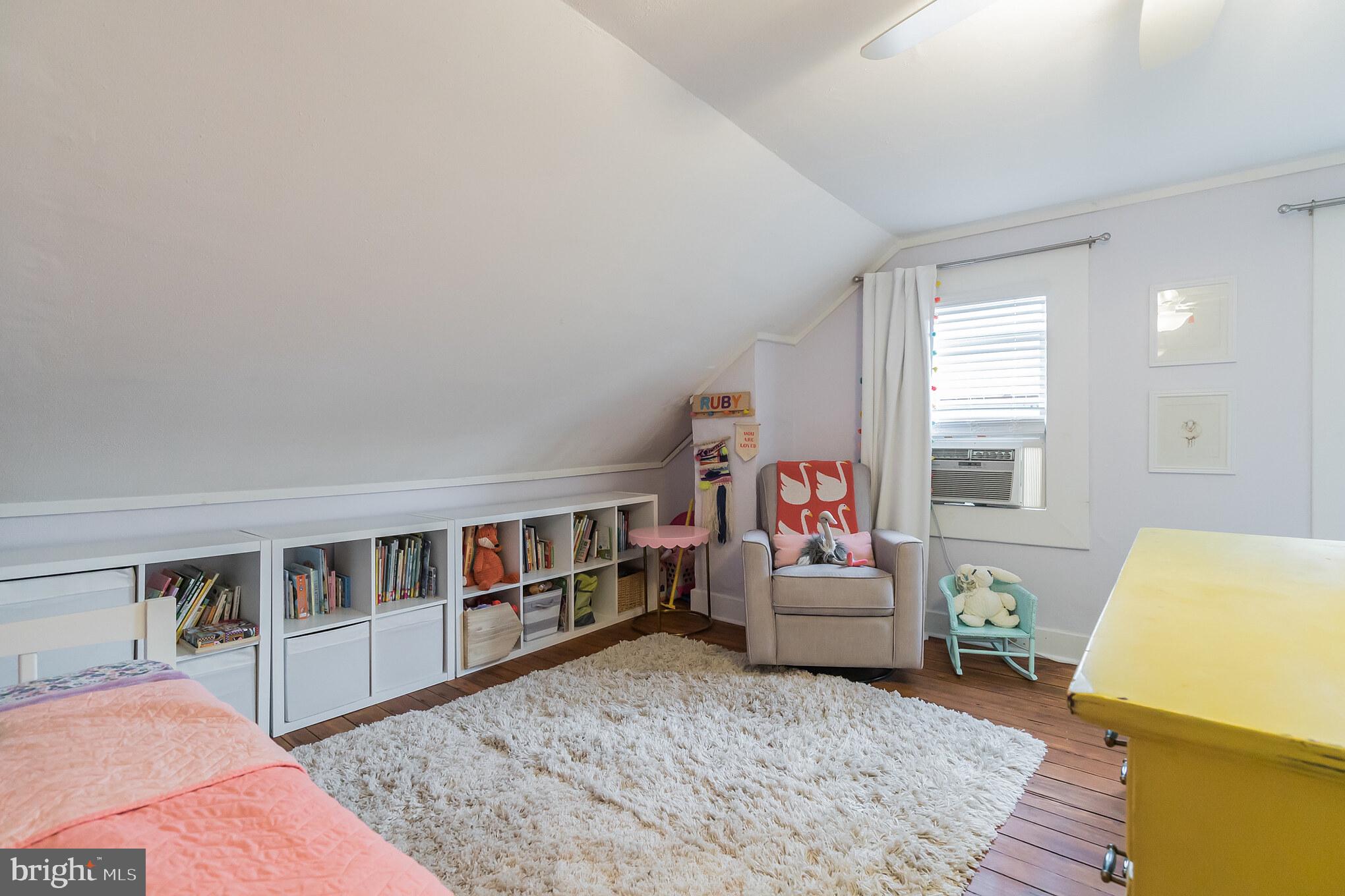 229 Benezet Street Philadelphia, PA 19118 - Photo 31 of 36 a bedroom with furniture and a book shelf