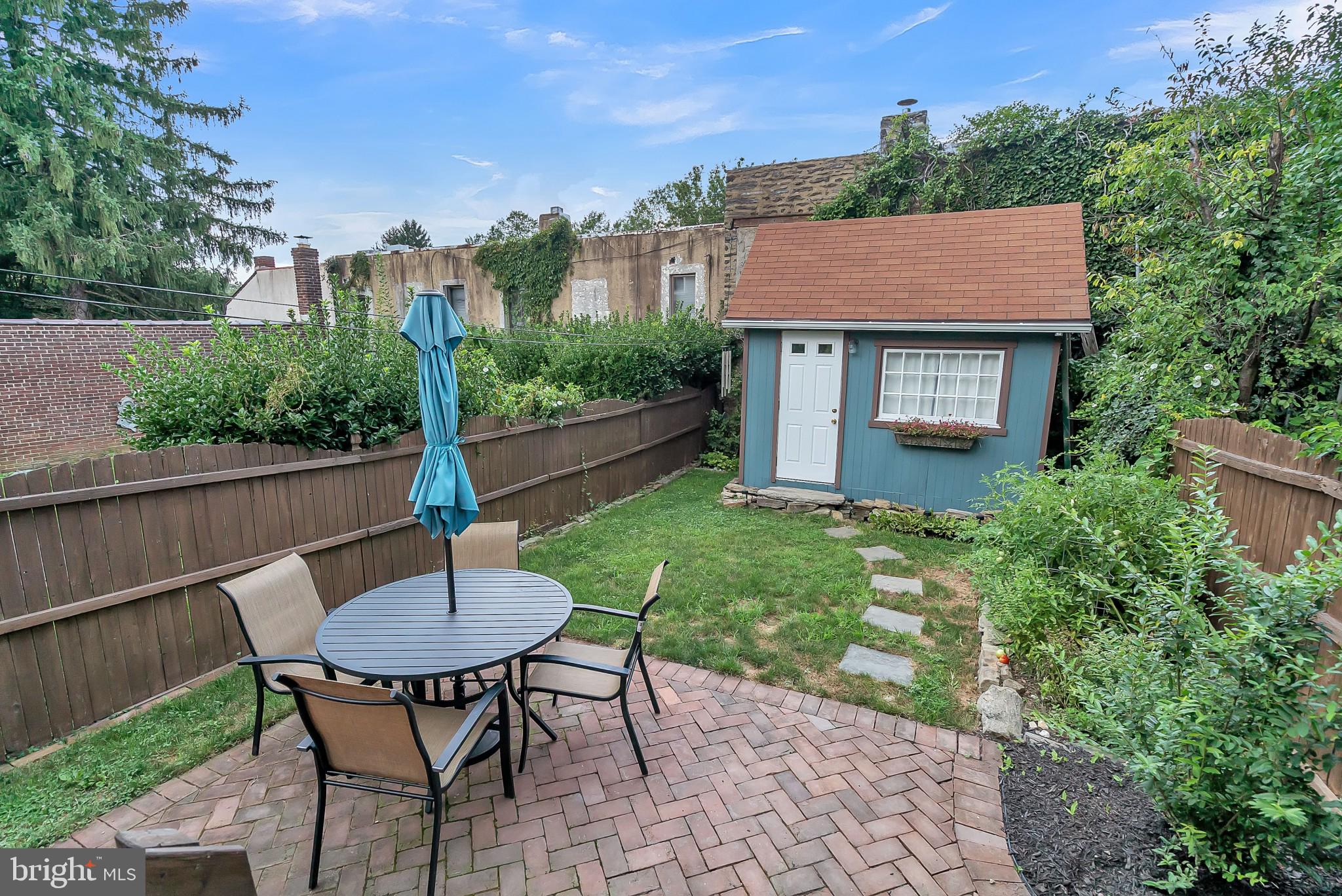 229 Benezet Street Philadelphia, PA 19118 - Photo 33 of 36 a view of a table and chairs in the yard