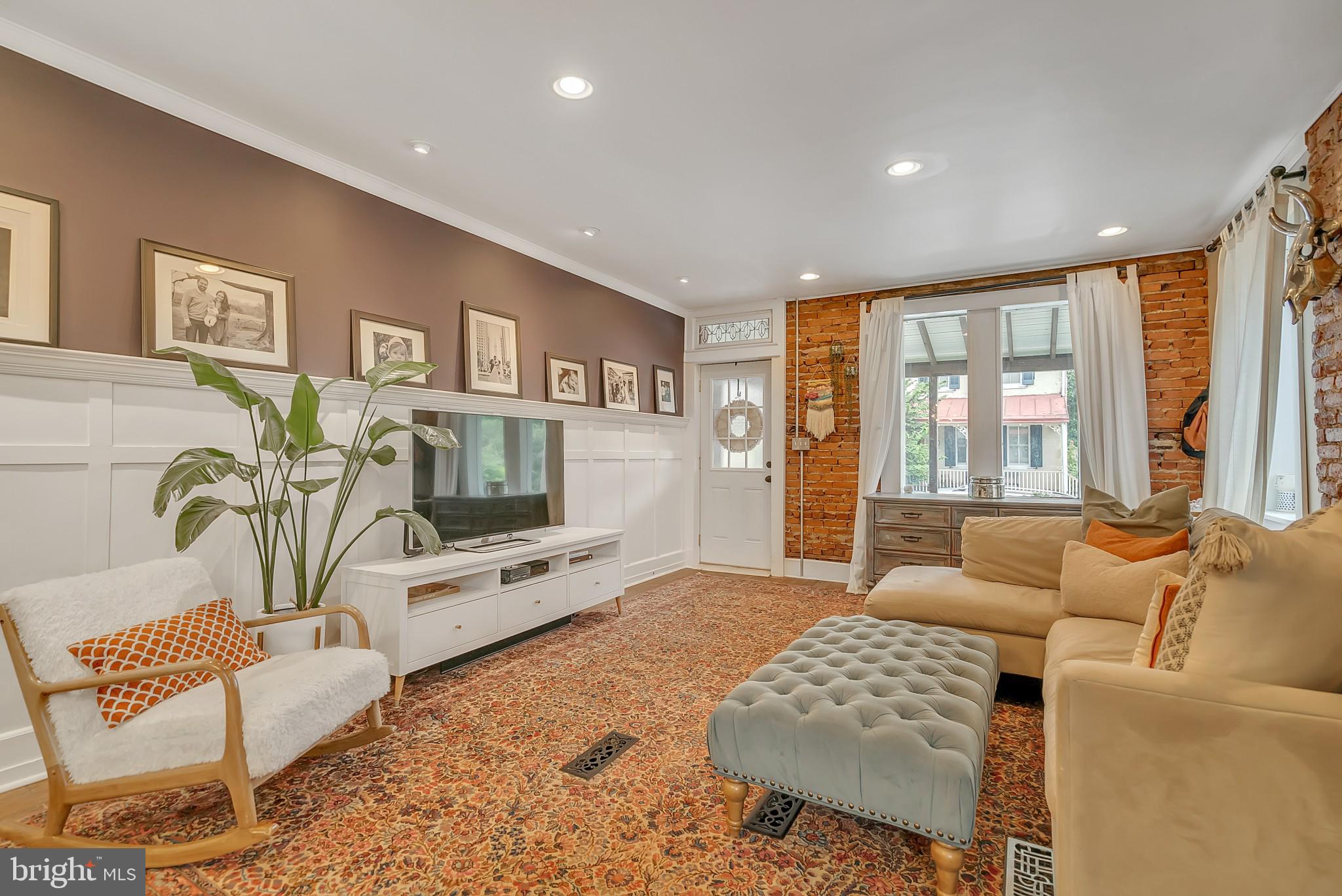 229 Benezet Street Philadelphia, PA 19118 - Photo 7 of 36 a living room with furniture and a flat screen tv