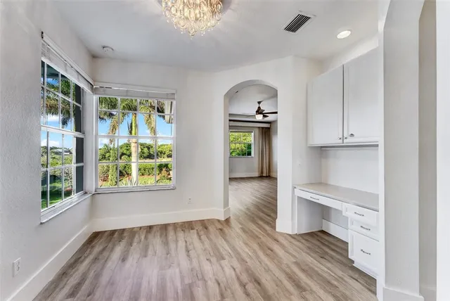 a kitchen with granite countertop a refrigerator and a sink